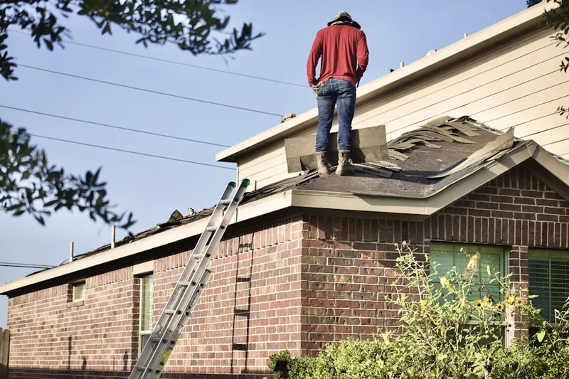 Professional roofer working on a residential roof in Baldwin